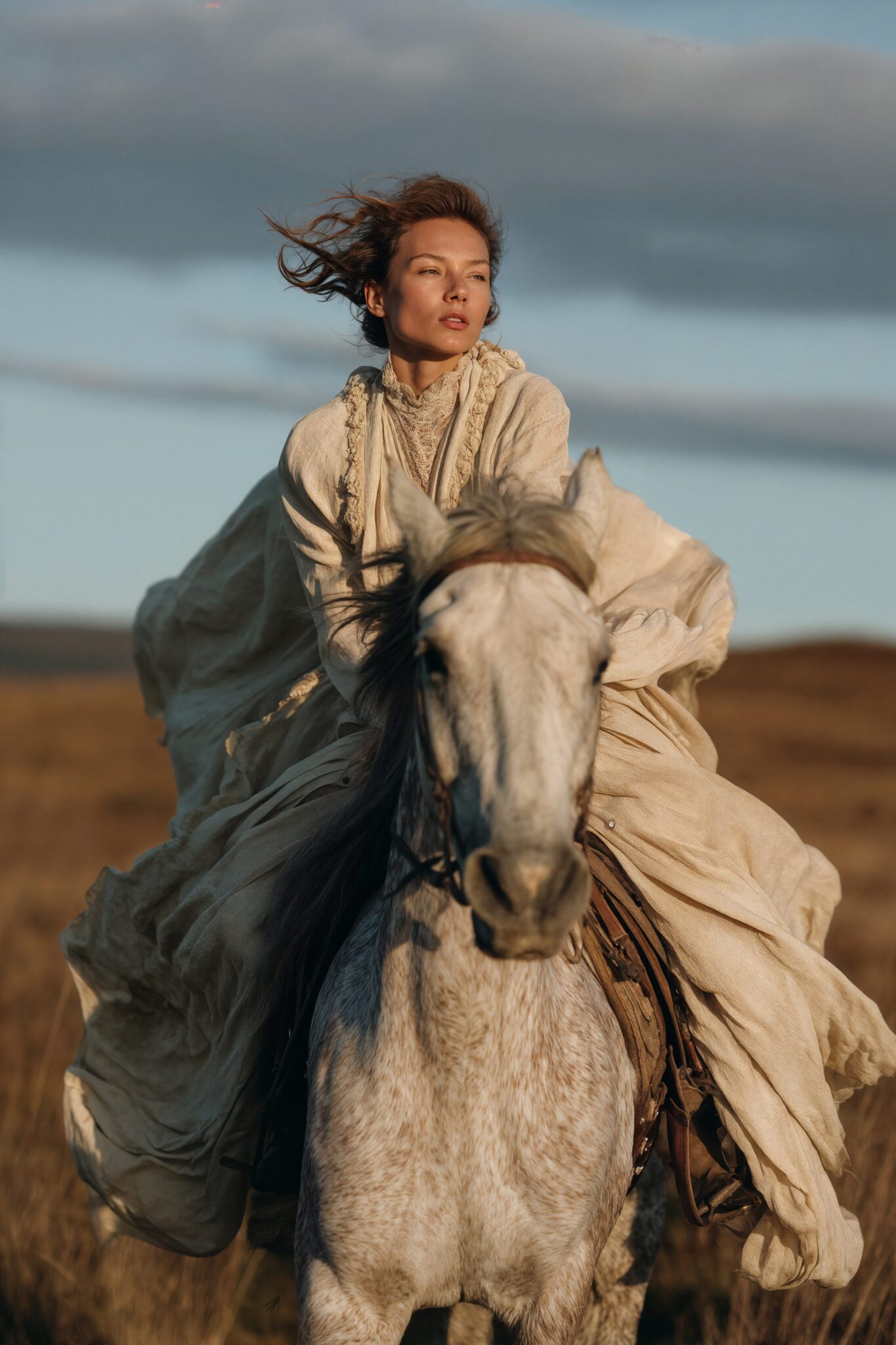 AI-generated fashion model riding a white horse in sunset light, flowing fabric, luxury editorial tone