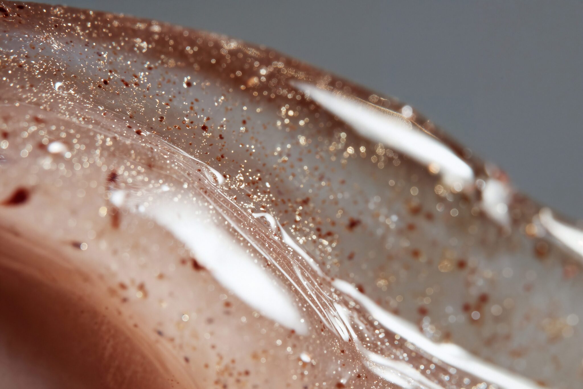 Macro AI visual of skincare gel with shimmer particles and reflective highlights, photoreal luxury tone