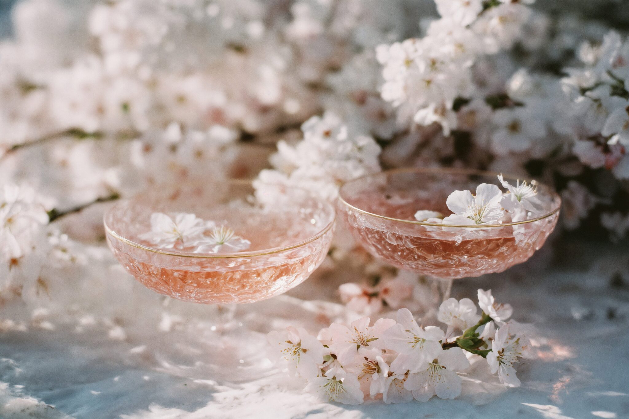 Photoreal AI macro of champagne glasses with floral details, cinematic light, elegant luxury mood