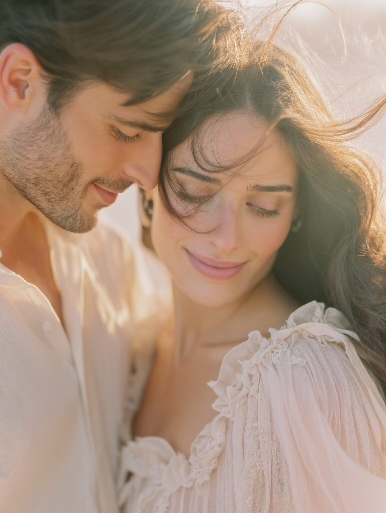 Photoreal AI visual of couple embracing in soft golden light, bridal editorial tone, cinematic atmosphere